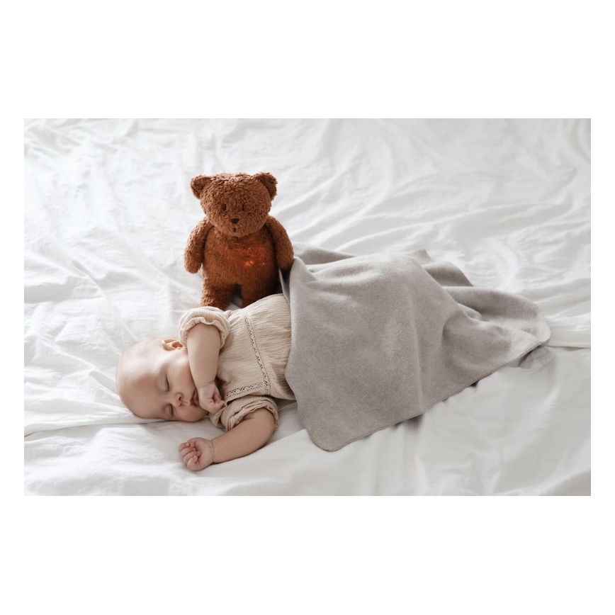 Moonie - Pelele con melodía y luz, pequeño oso de miel orgánica en tono caramelo natural