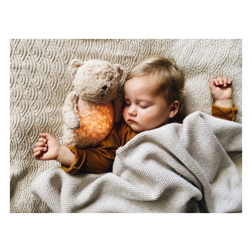 Moonie - Pelele con melodía y luz, pequeño oso de miel orgánica en tono rosado natural