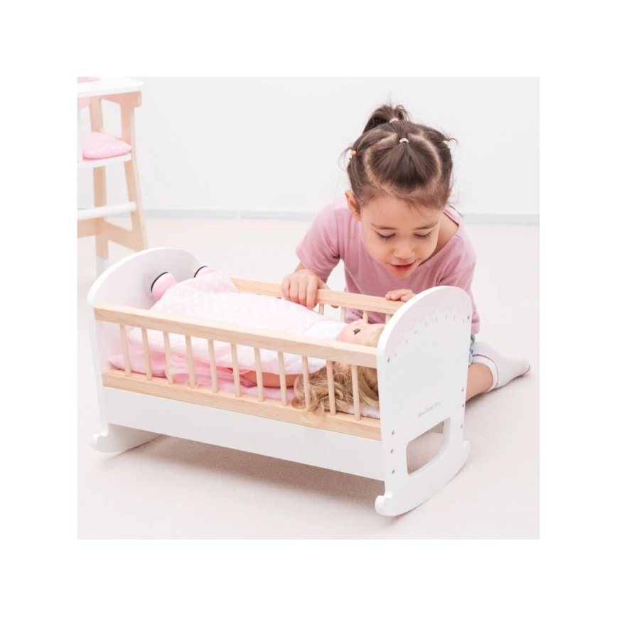 New Classic Toys - Cama de madera para muñecas rosa